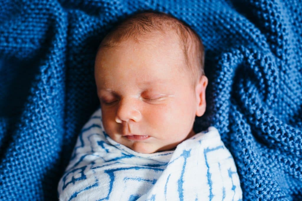 newborn baby in handmade blue blanket north shore newborn photographer