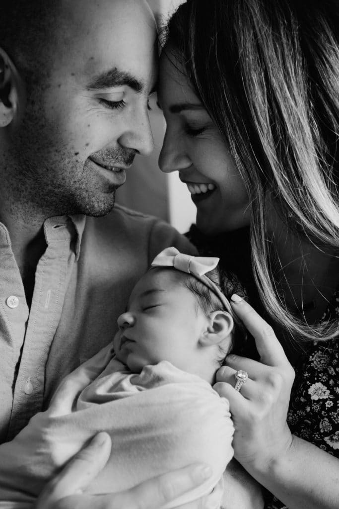 mom and dad holding baby south shore newborn photographer