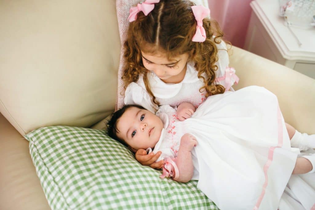 big sister holding little sister weston newborn photographer