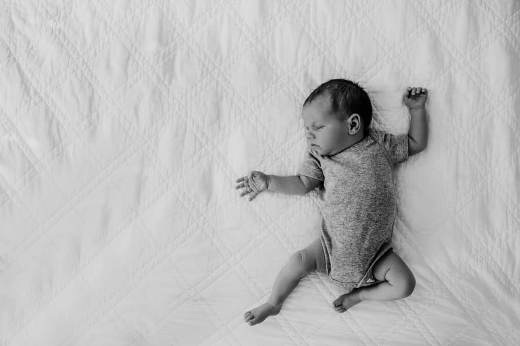baby sleeping on bed north shore newborn photographer