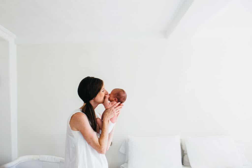 Mom kissing baby Concord newborn photographer