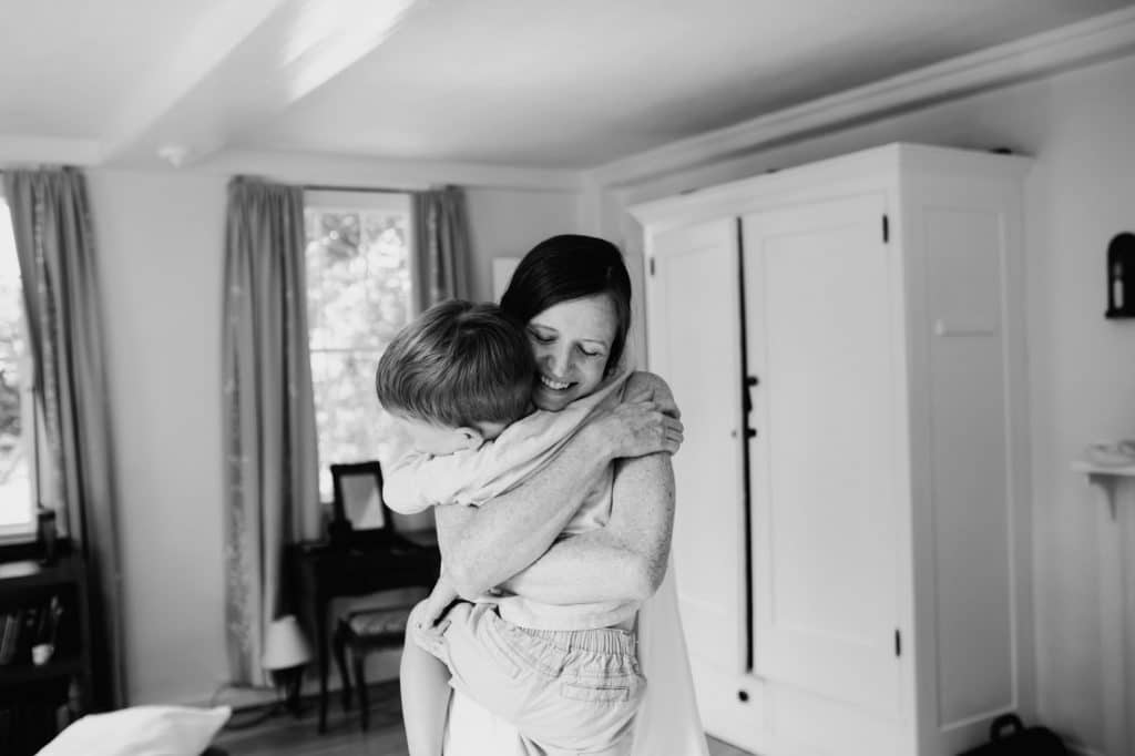 Mom hugging son Concord newborn photographer