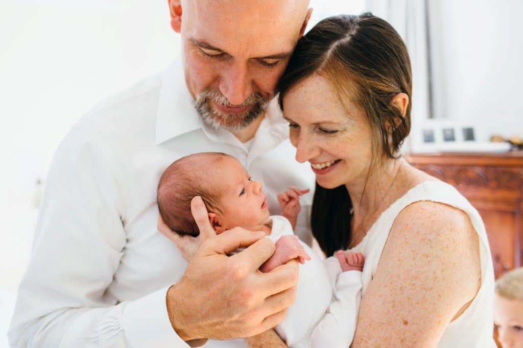 mom and dad with baby Concord newborn photographer