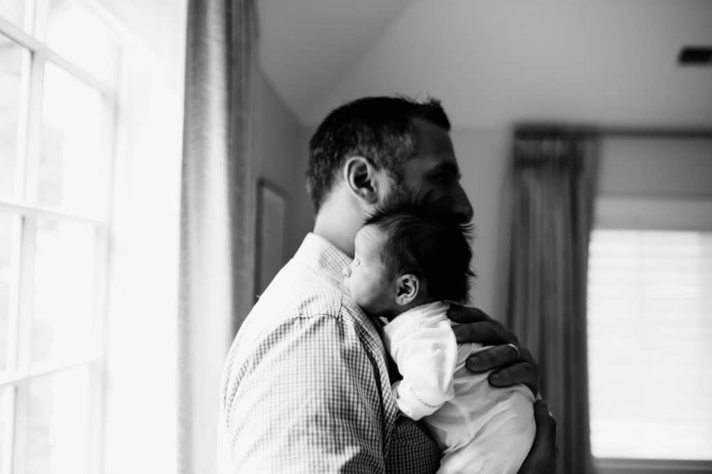 dad holding baby on his shoulder Weston newborn photographer