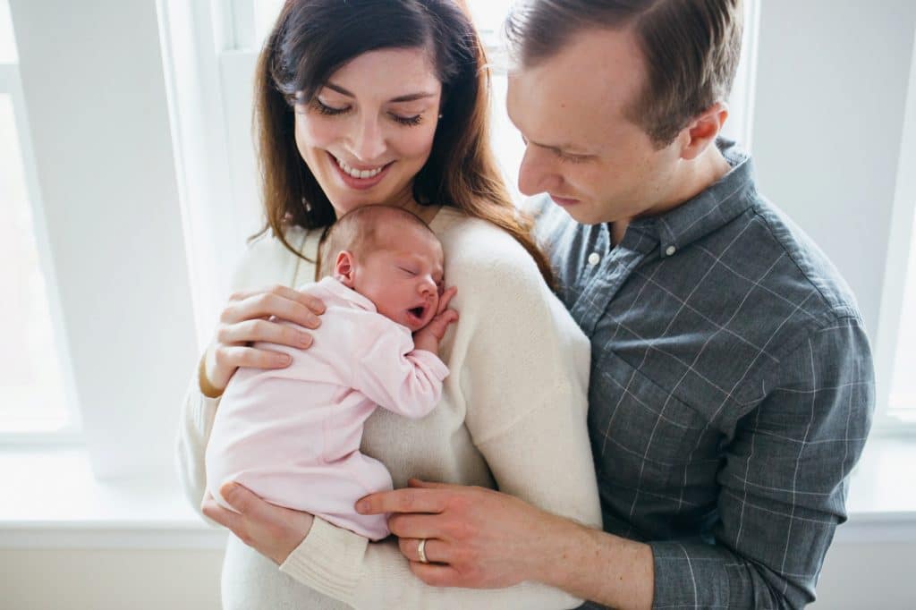 mom and dad holding baby Charlestown newborn photographer
