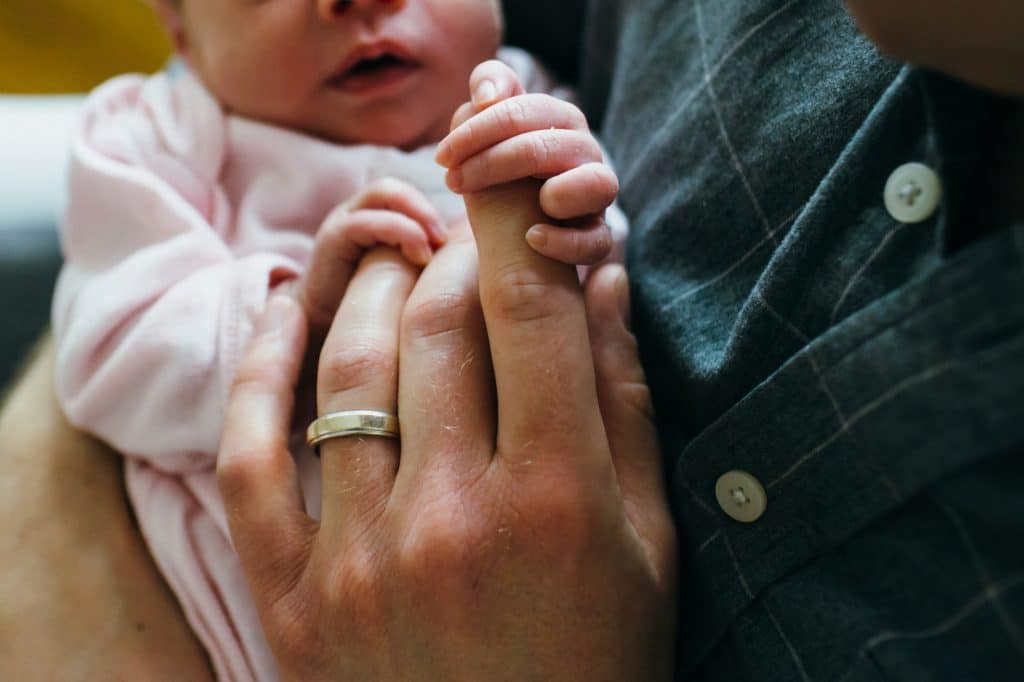 baby holding dad's finger Charlestown newborn photographer