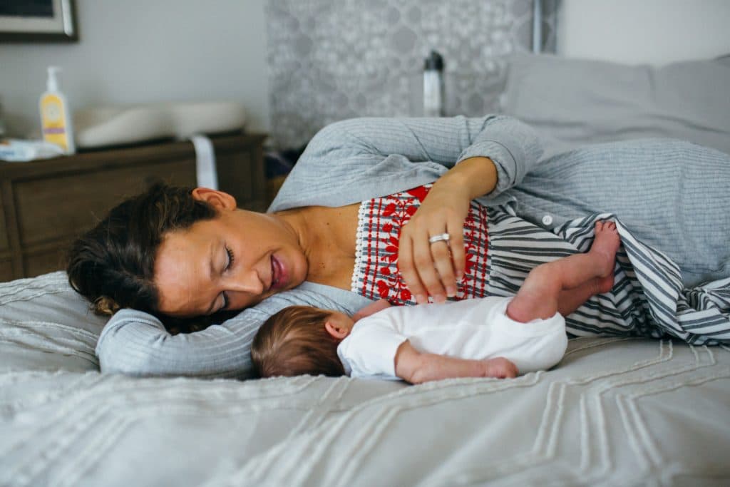 mom laying with new baby Belmont newborn photographer