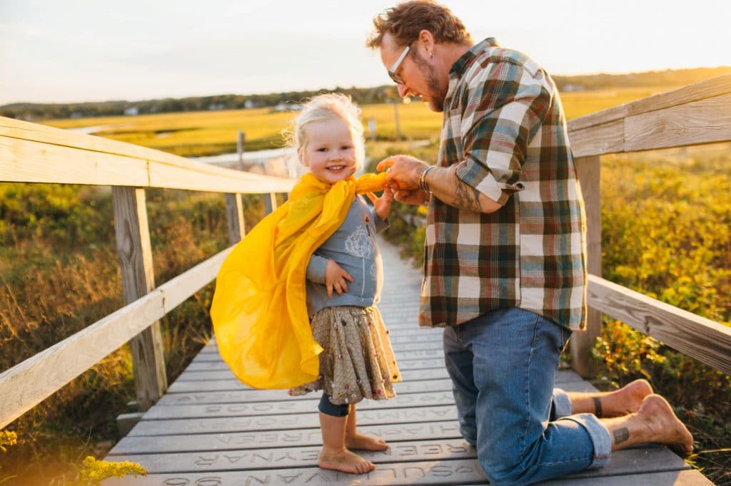 dad putting daughter's cape on South Shore Family photographer