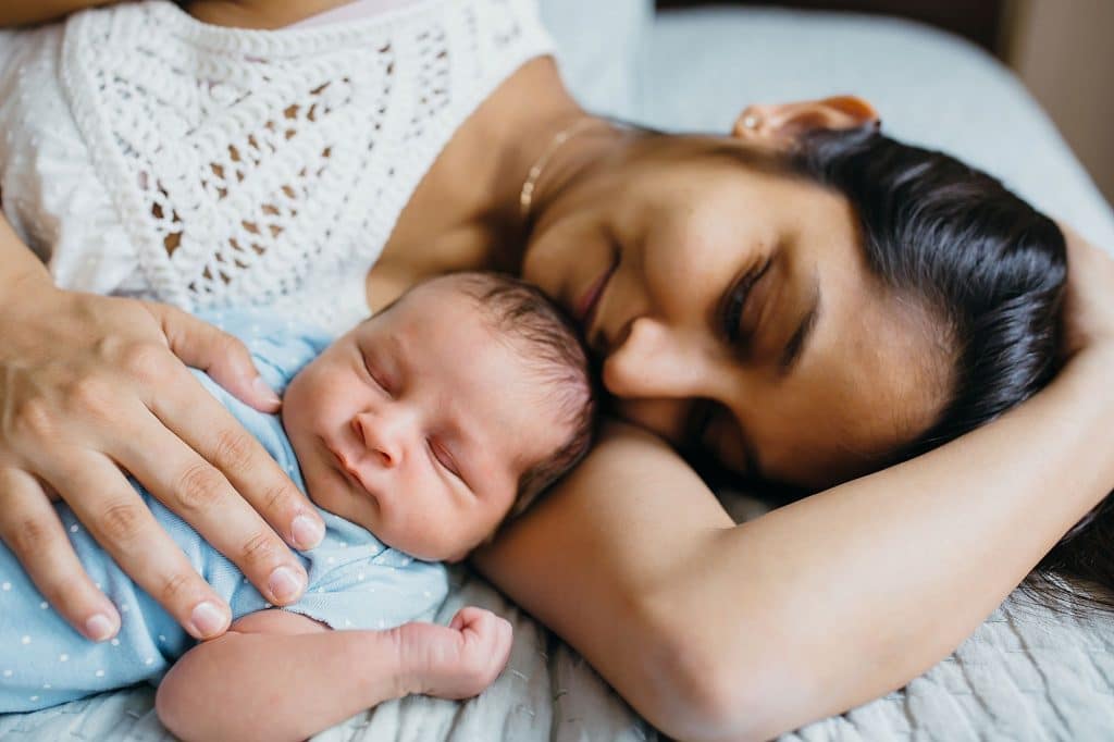 mom sleeping with newborn lexington baby photographer