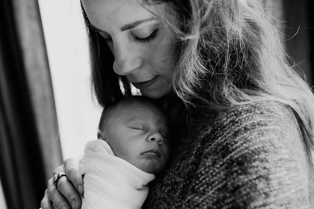 mom snuggling with baby Somerville Newborn photos