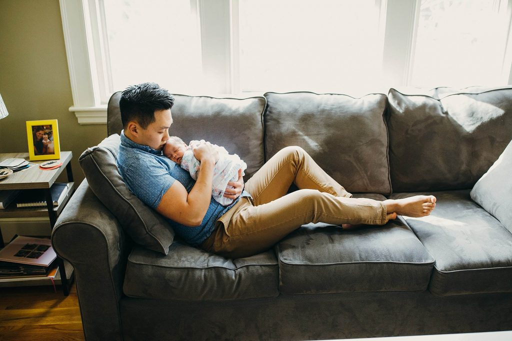 dad on couch with baby brookline newborn photographer