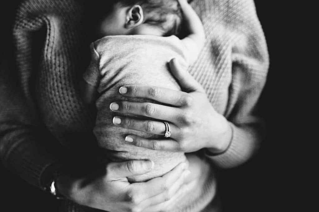 mom holding baby brookline newborn photographer