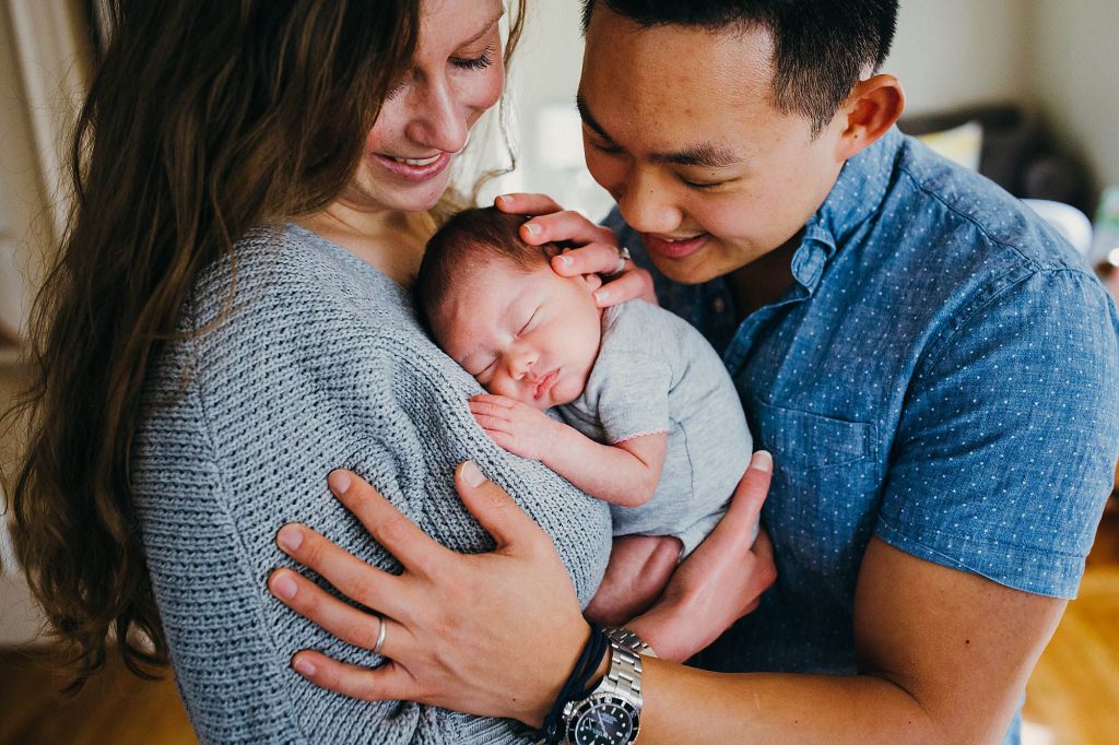mom and dad holding baby brookline newborn photographer