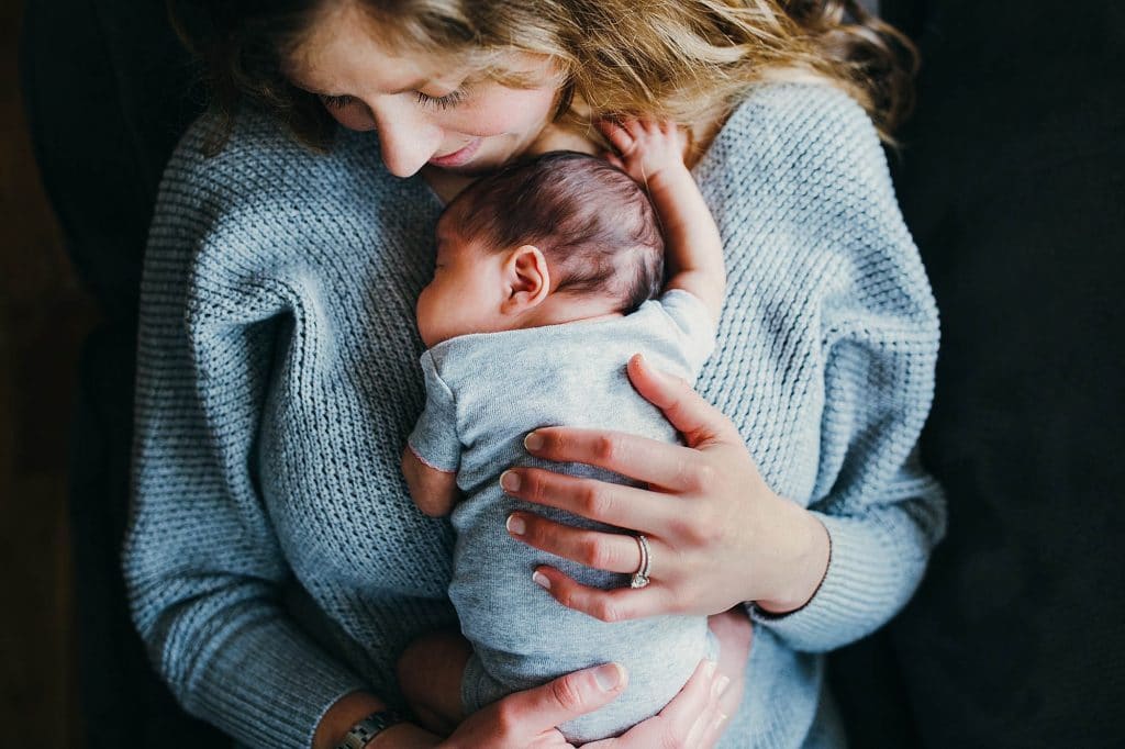 mom holding baby brookline newborn photographer