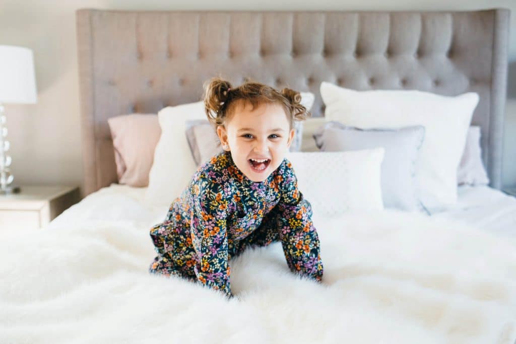 girl getting ready to jump on the bed Needham Family Photographer