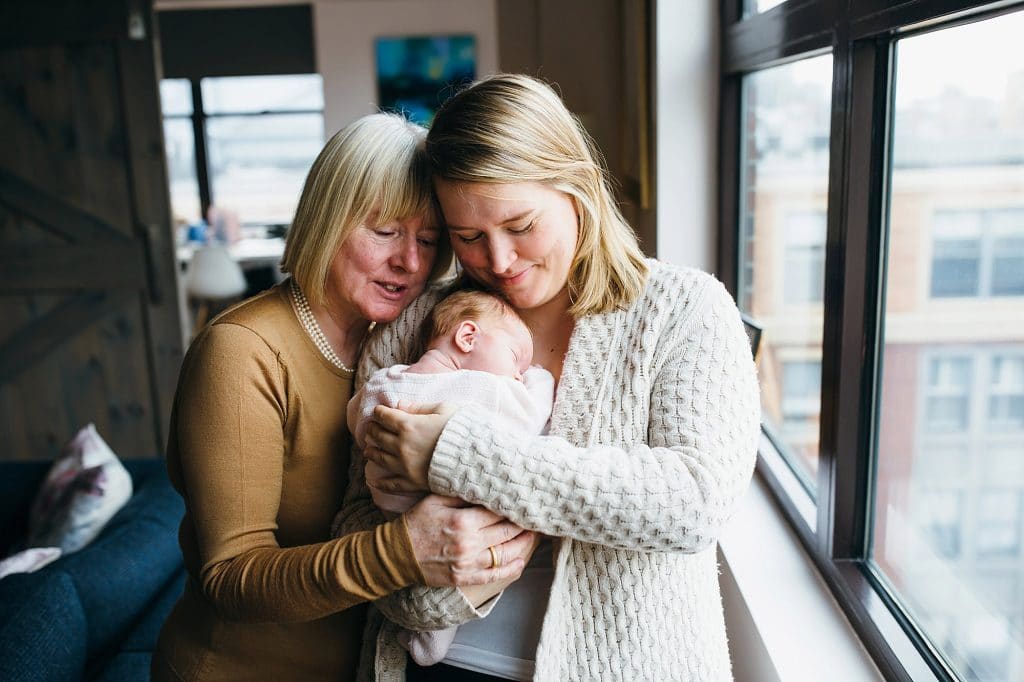 mom, grandmother and baby snuggling Boston newborn photographer