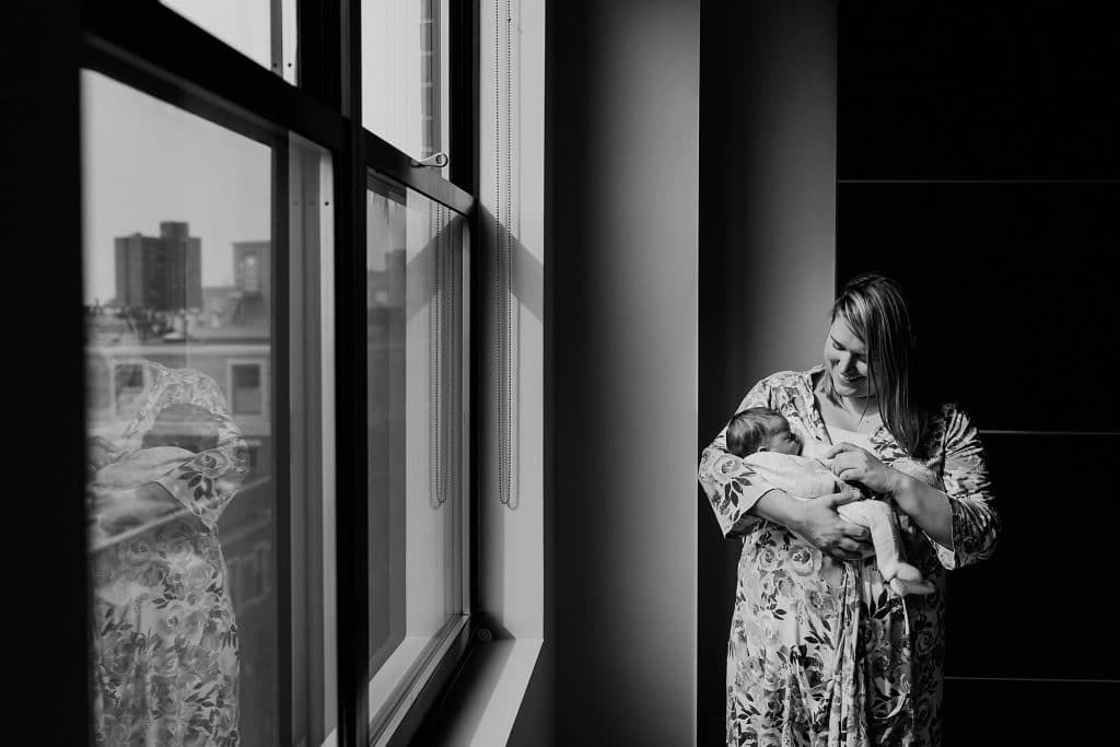 mother snuggling newborn Boston baby photographer