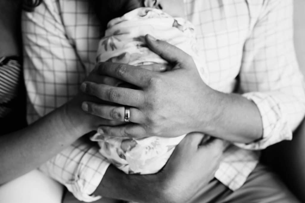 parents hand holding baby Boston newborn photos