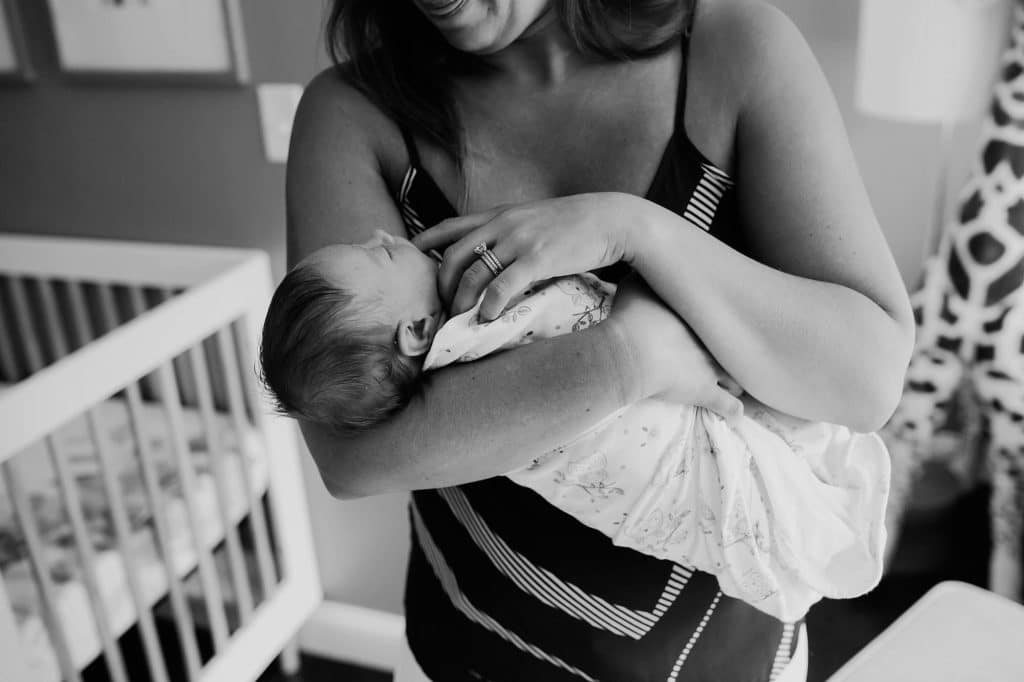 mom using finger as a pacifier South Shore newborn photographer 