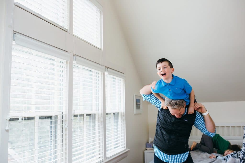 dad tossing son onto bed boston family photographer