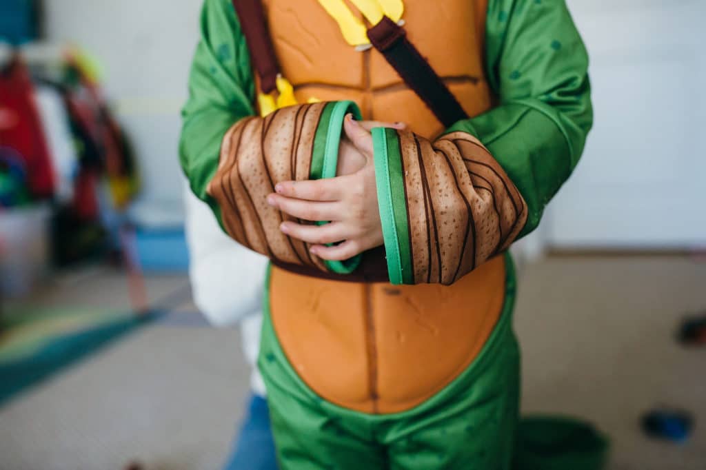 boy wearing a teenage mutant ninja turtle costume Wouth Shore family photographer
