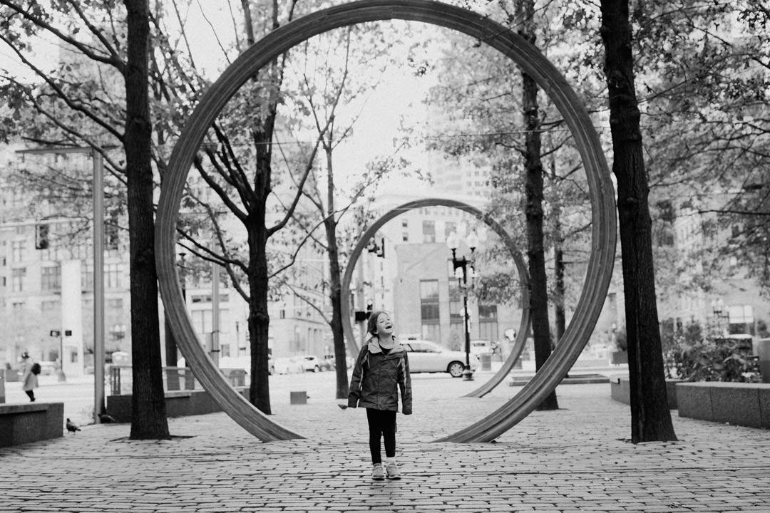 girl walking through art circles in Boston