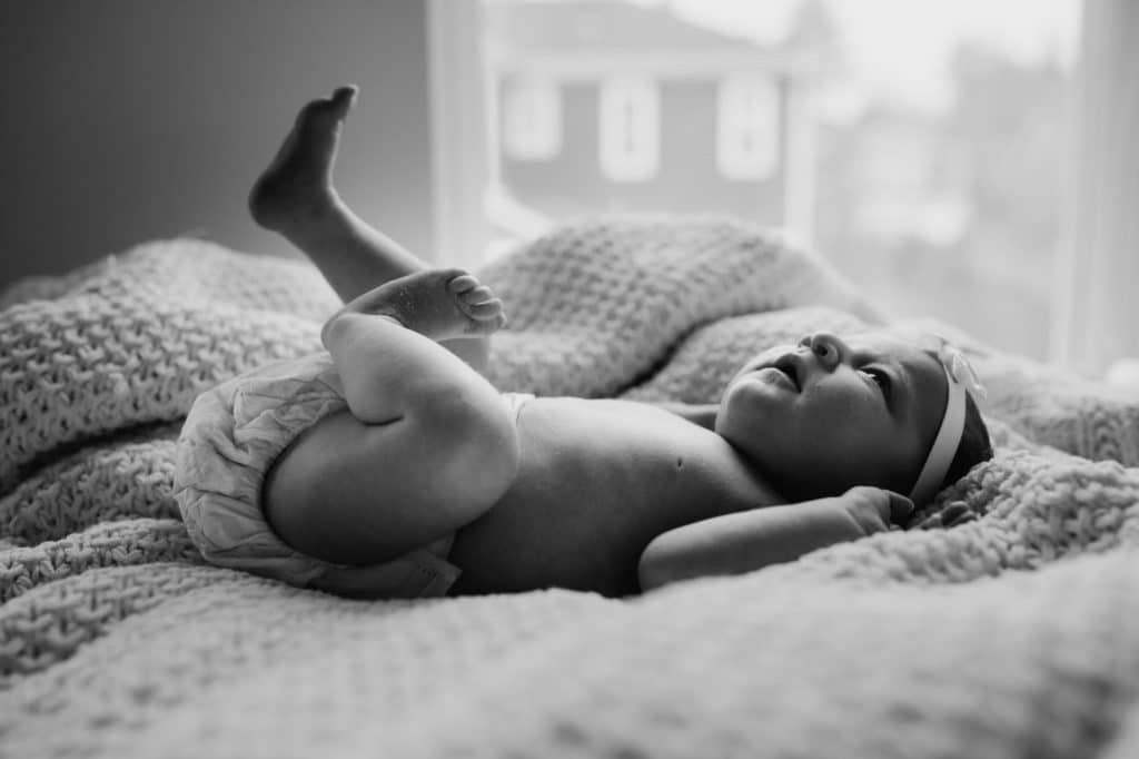 baby with foot in the airi Concord Newborn photographer