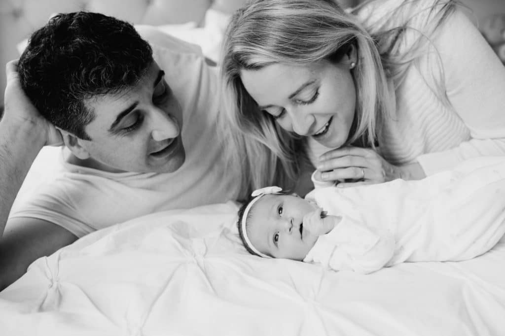 parents looking adoringly at newborn concord baby photographer