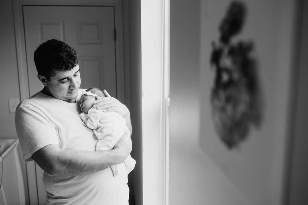 Dad holding baby Concord newborn photographer