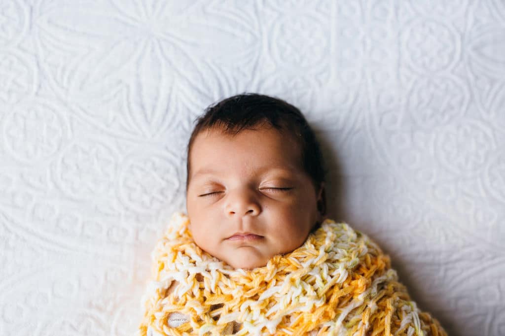 baby wrapped up in handmade yellow blanket Watertown newborn photos 