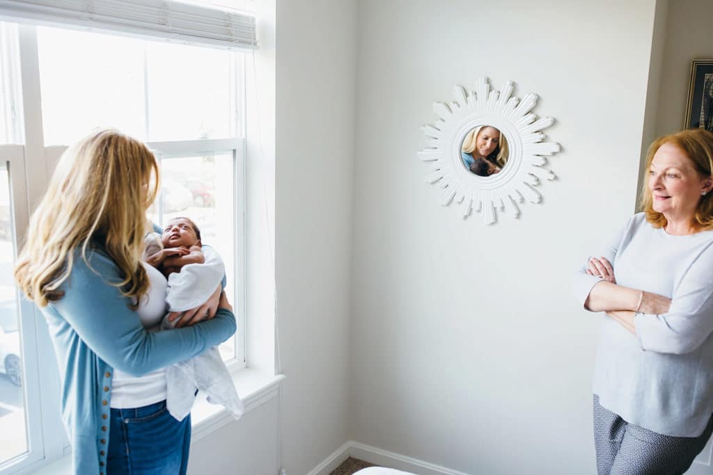 grandmother gazing at daughter holding baby lifestyle photography 
