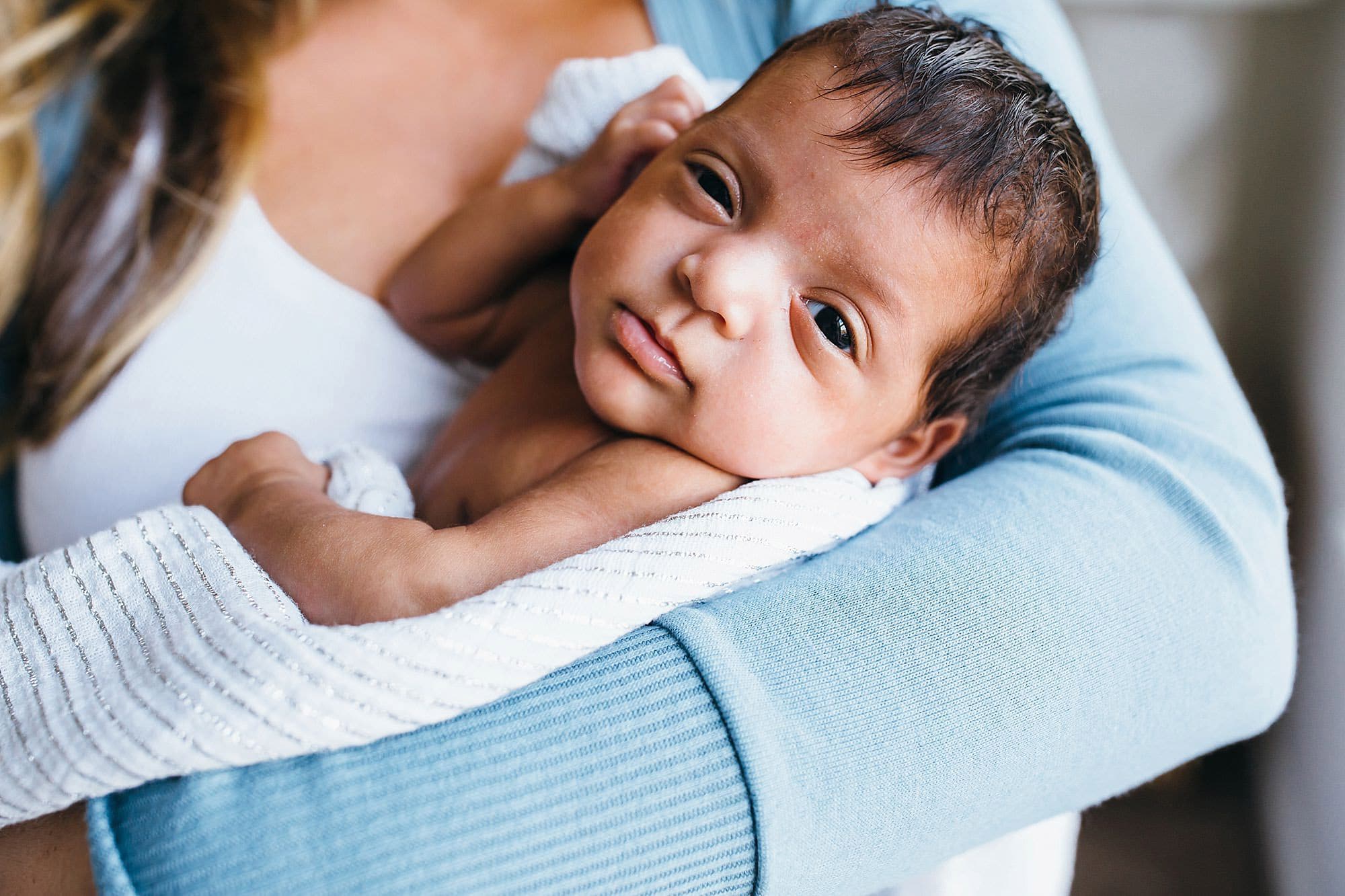 Beautiful baby in mom's arms Watertown newborn photographer