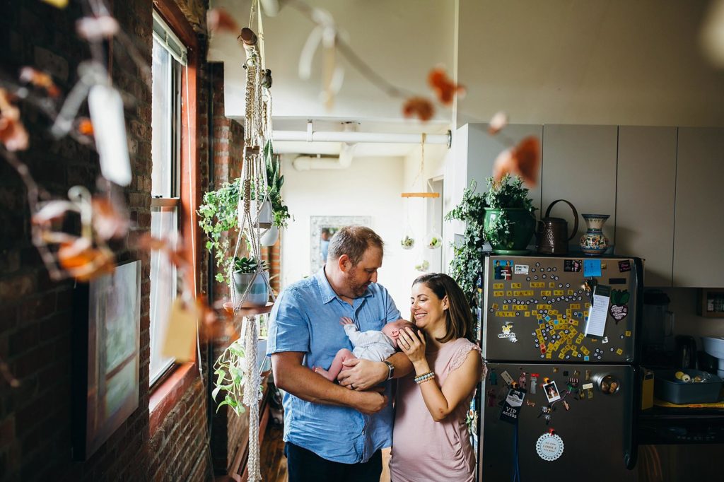 new parents with baby and plants boston newborn photographer