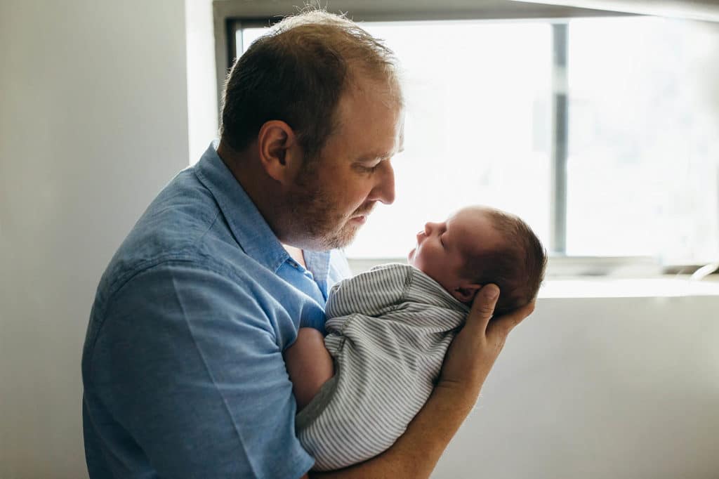 dad looking at baby lovingly boston newborn photographer