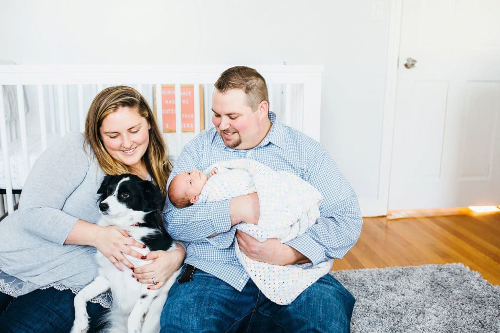parents with baby and dog in nursery dedham newborn photographer 