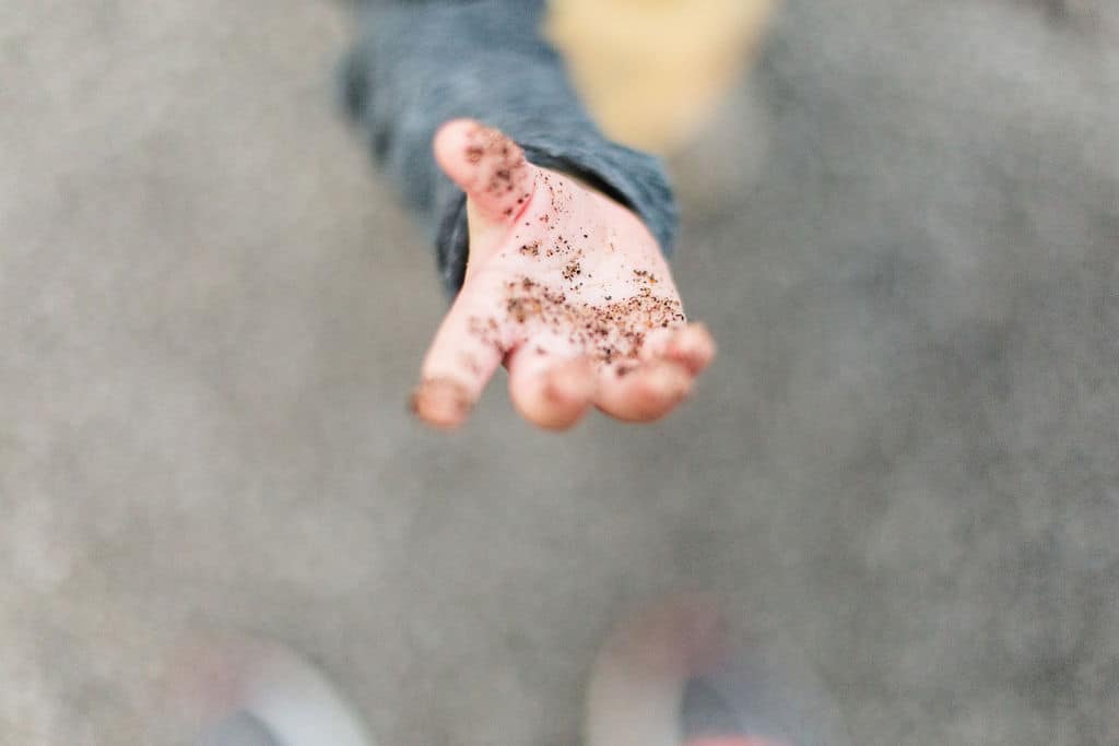 detail of hands in dirt