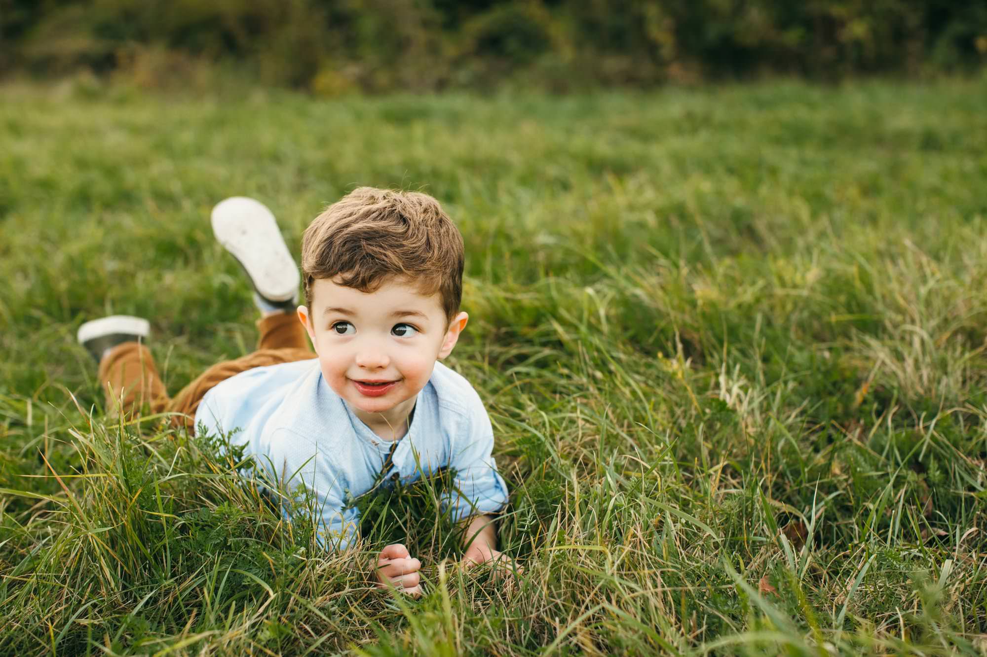 Boy siting in grass Belmont Family Photography