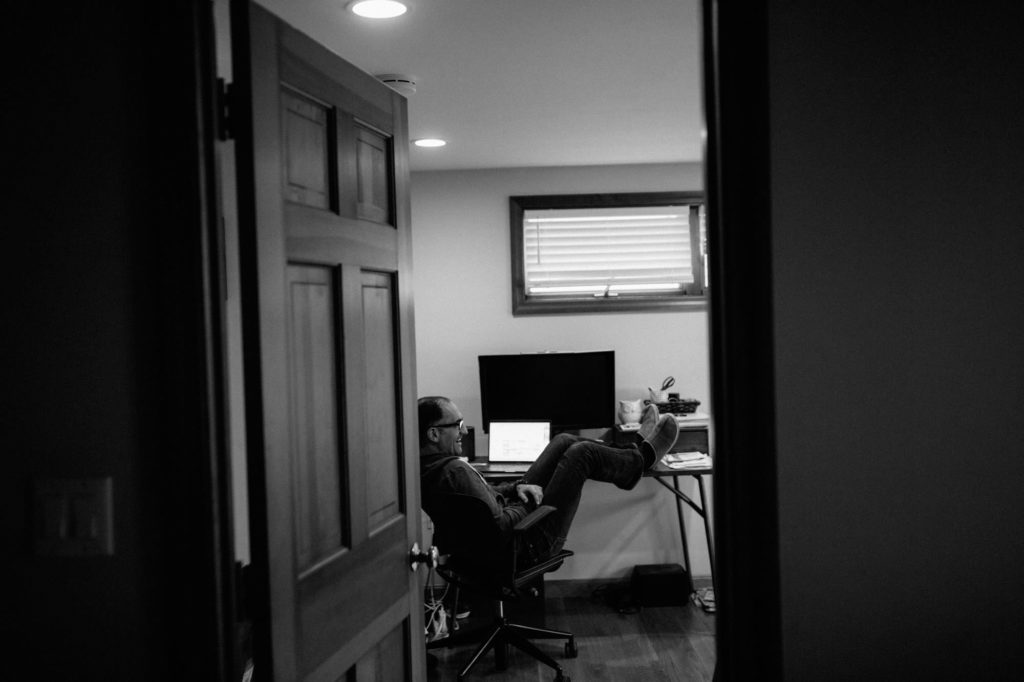 man relaxing a computer desk