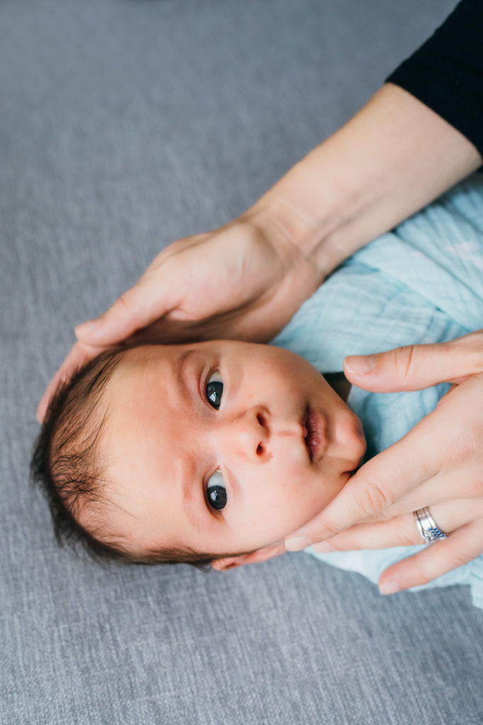photo of baby in his mom's hand Newborn Photographer in Boston