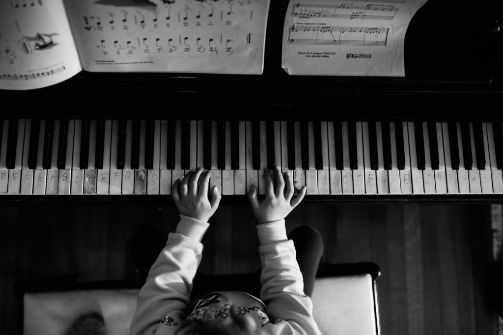 piano lesson with letters written on the keys in black and white image
