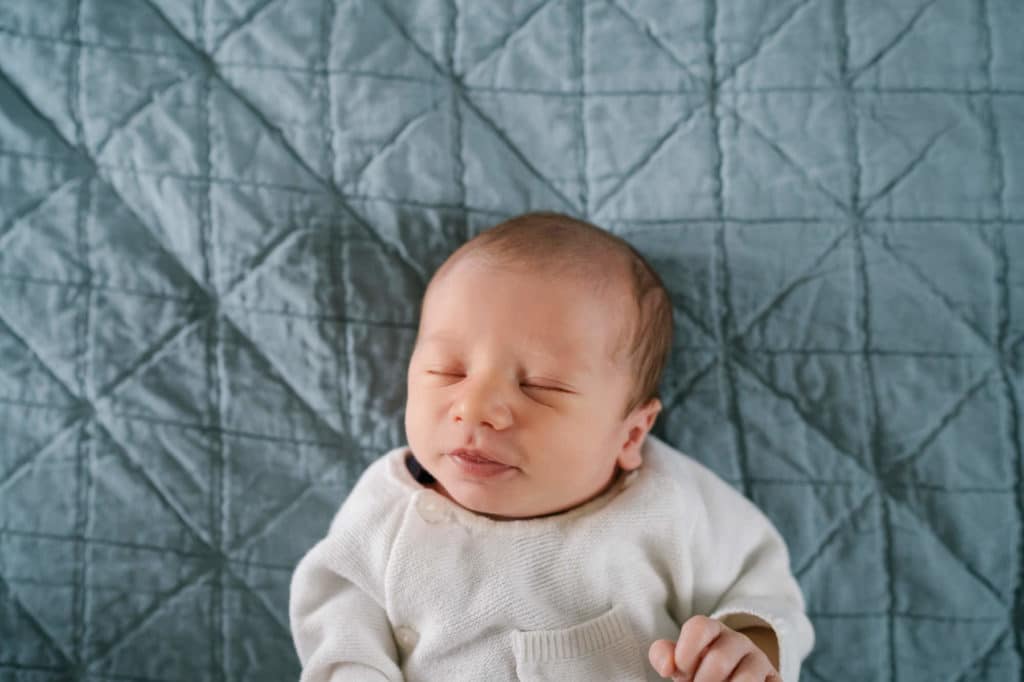 portrait of newborn baby on blue bed