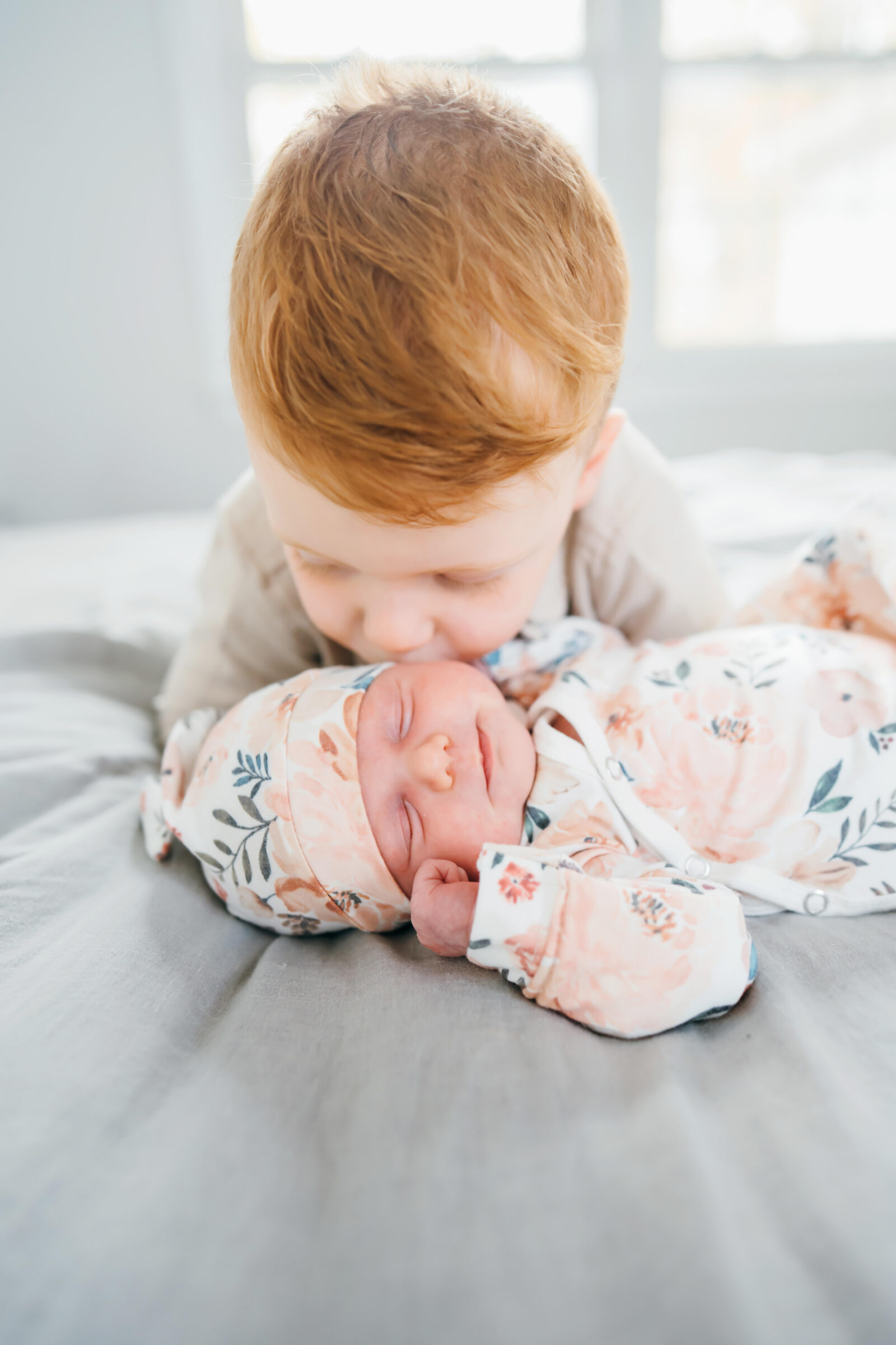 photo of boy kissing baby in Boston home